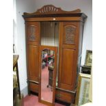 Early XX Century Walnut Wardrobe, with a central mirror, over a long drawer, on turned feet.