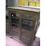 An Early XX Century Stained Mahogany Bookcase, stepped cornice glazed doors, knulled sides, on