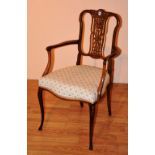 An Edwardian rosewood inlaid parlour armchair, with serpentine shaped floral upholstered seat,