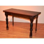A 19th century mahogany side table, raised on turned supports,