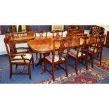 A good quality reproduction hardwood dining table with eight matching dining chairs,