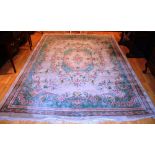 A Chinese style carpet, decorated with foliate panels within a cream ground,