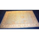 A hand woven floor rug of Pakistan origin, the floral motif on pale blue ground, with cream border,