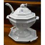 A white glazed pottery tureen on stand, with ladle,