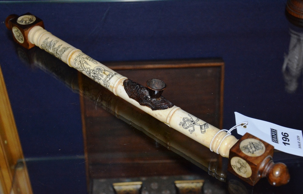 A Chinese opium pipe, mounted in ivory with etched figures and serpents in foliage,