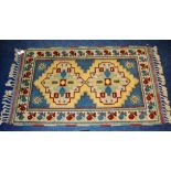 A small Persian rug, decorated with two geometric medallions to the centre, on white, yellow,