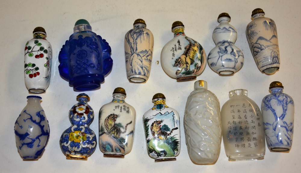 A quantity of Chinese glass and porcelain scent bottles, together with similar examples,