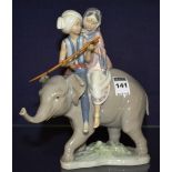 A Lladro figure group of two children on elephant,