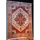 A Heriz silk rug, decorated with central foliate medallion, within a cream ground,