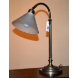 An adjustable desk lamp, with glass shade,