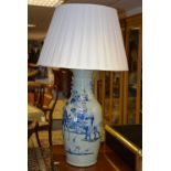 A Chinese glazed pottery table lamp with shade, decorated with figures, animals and birds,