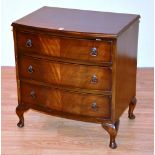 A reproduction mahogany chest of drawers, of small form, with three graduated drawers,