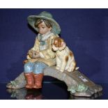 A Lladro matt glazed figure group of child with dog sitting on bridge,