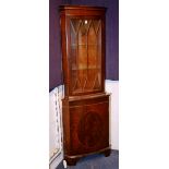 A reproduction corner cabinet, with glazed door, converted to electricity,