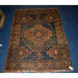 A small Persian rug, decorated with central medallions, floral and geometric background,