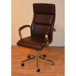A contemporary chrome effect and brown leather swivel desk chair,