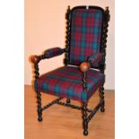 An ebonised barley twist throne type armchair, the arm rests ending in ball roundels,