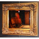 A reproduction gilded wall mirror, in the Victorian style,