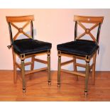 A pair of light oak breakfast bar chairs by Clive Christian, the back rest with X-form stretchers,