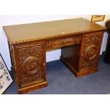 A late 19th/early 20th century carved kneehole desk,