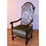 An early 20th century 17th century style mahogany armchair, with scroll arm rests,