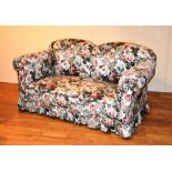 A floral upholstered two seater drop end settee,