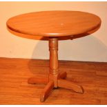 A modern drop leaf kitchen table, raised on quad supports,