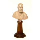 A late 19th century carved ivory bust of a gentleman, raised on turned wooden stand,