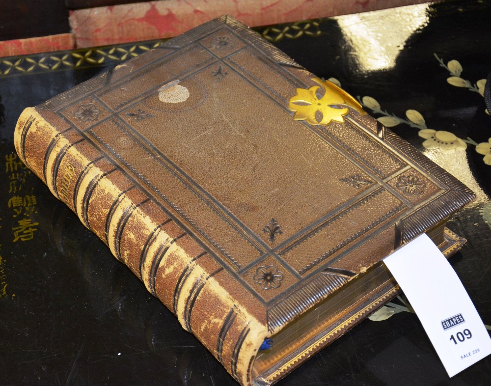 A late 19th/early 20th century leather bound holy bible, with gilt metal clasp,