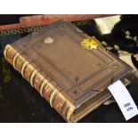 A late 19th/early 20th century leather bound holy bible, with gilt metal clasp,