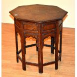 A Burmese octagonal folding occasional table, decorated with brass foliate panels, 64cm high x 60.