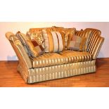 A good quality two seater settee by Gascoigne Designs, upholstered in gold Regency style stripe,