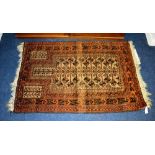 A small Persian reversible rug, with geometric decoration on orange and black ground,