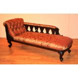 A late Victorian mahogany framed chaise longue, upholstered in later red and gold floral moquette,