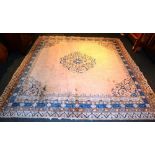 A Chinese Type Carpet, the foliate motif on fawn background, with blue and brown foliate border,