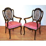 A pair of Edwardian mahogany ladies and gents parlour armchairs,