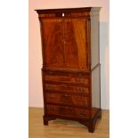 A reproduction mahogany panelled cupboard on chest,