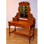 A late Victorian mahogany dressing table, the swing mirror raised above two drawers,