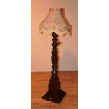 An early 20th century carved mahogany floor lamp with shade,