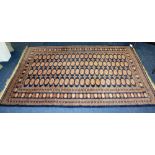 A Persian style rug, decorated with four rows of 22 motifs, on red and blue ground,