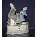 A Royal Copenhagen figure group in the form of an 18th century style man and woman,