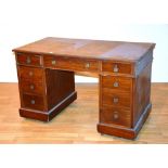 A Victorian mahogany pedestal desk, the top section with three graduated drawers,