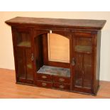 An Arts & Crafts style mahogany glazed bookcase top, with fitted drawers, flanked by glazed door,