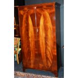 A mahogany wardrobe, with two panelled doors,