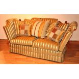 A good quality two seater settee by Gascoigne Designs, upholstered in gold Regency style stripe,