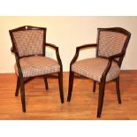 A pair of stained wood elbow chairs, upholstered in later checked fabric,