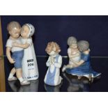 Two Bing & Grondahl figure groups, of boy and girl in embrace, 12 & 18cm high,