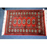 A Persian prayer mat, decorated with four central medallions and geometric border,