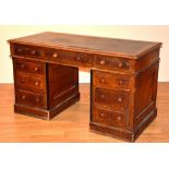 A Victorian oak kneehole desk, with tooled leather inset to top,