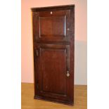 A George III oak corner cupboard,